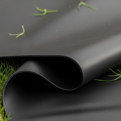Close-up of black LDPE flexible pond liner material texture - budget pond liner UK