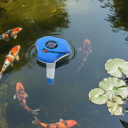 Solar powered pond thermometer floating in garden pond with koi fish