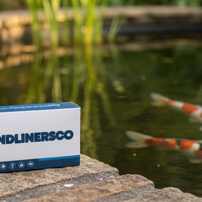 Pond water test kit beside a clear UK garden koi pond – PondLiners Co