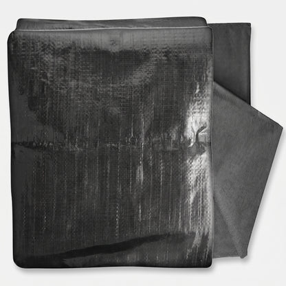 Folded black HDPE pond liner with its dark grey protective underlay