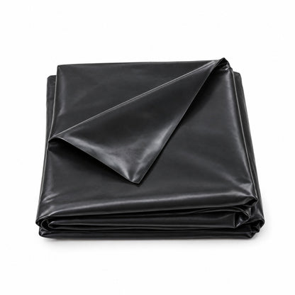 Small folded black PVC pond liner with the top fold lifted on a white background