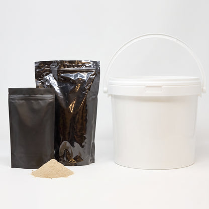 Cold water pond bacteria powder in two black pouches and a white 5kg tub with a heap of beige powder on a white background